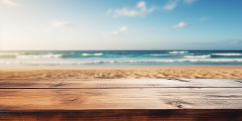 Empty wooden table with with blurry beach and ocean in background - obrazy, fototapety, plakaty