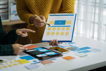 designer brainstorming about mobile app interface wireframe design with customer breif and color...