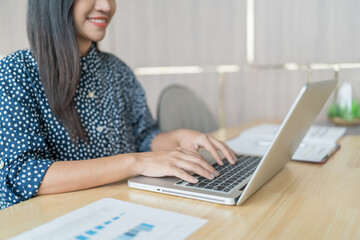 Beautiful Business Woman working by using laptop computer Hands typing on keyboard. Professional investor working new start up project. business planning in office. Technology business Concept