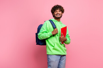 Portrait of young cheerful positive student hipster indian guy hold copybooks wear rucksack behind...