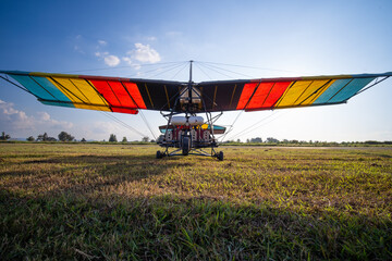 glider airplane. Small aviation sport. The motorized hang glider parked at the airfield at...