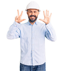 Young handsome man wearing architect hardhat showing and pointing up with fingers number eight while smiling confident and happy.