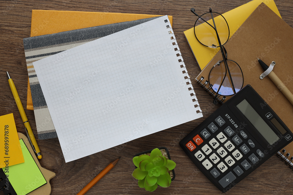 Poster modern office desk with notepad and other accessories. empty space for copy text. calculator and gla