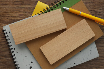 wooden block on a wooden background. yellow pen