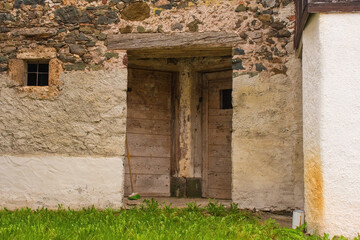Fototapeta na wymiar Doors in an abandoned building in the mountain village of Magnanins near Rigolato in Carnia, Friuli-Venezia Giulia, north east Italy