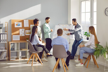 Group of business people chatting on a meeting sitting in circle in office. Company employees discussing work project. Coworkers listen to their colleague. Corporate business team concept.