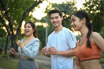 Group of sporty young people jogging together in the morning sunrise. Healthy Lifestyle concept