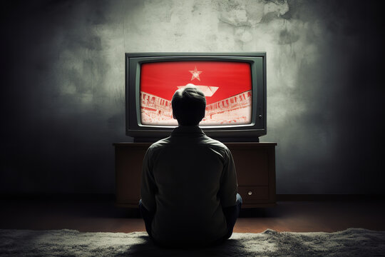 Lonely individual exposed to extremist propaganda - watching brainwashing content on TV - highlighting the danger of radicalization.