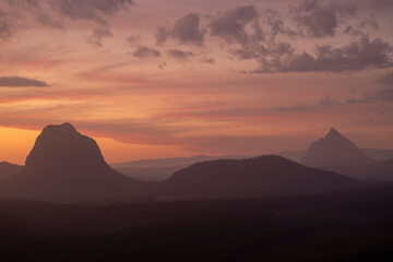 Fototapeta na wymiar Tourists visit the Wildhorse scenic lookout for sunset panoramic views across the Glasshouse Mountains and the Sunshine Coast in Queensland