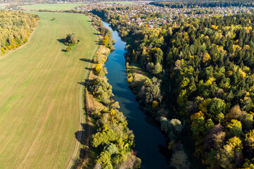 Drone view of land with flowing river in countryside