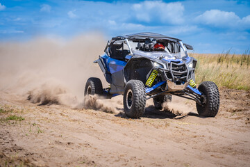 Fototapeta na wymiar UTV in action offroad vehicle racing on sand dune. Extreme, adrenalin. 4x4.