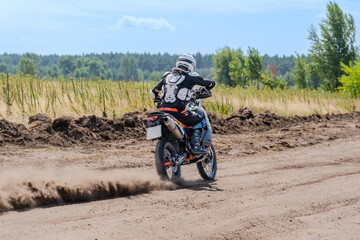 Motocross rider riding on extreme dust track