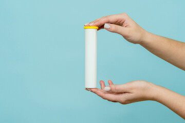 Tube for vitamins, pills in hand. Packaging. Mockup