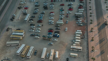 Aerial view of a parking lot with many cars in rows timelapse