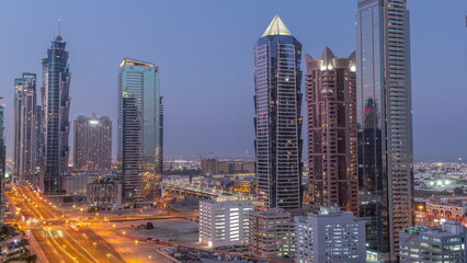 Business bay district skyline with modern architecture night to day timelapse from above.