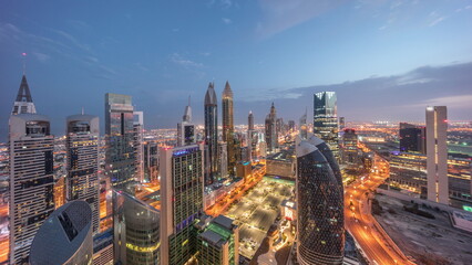Skyline view of the high-rise buildings on Sheikh Zayed Road in Dubai aerial night to day timelapse, UAE. - obrazy, fototapety, plakaty