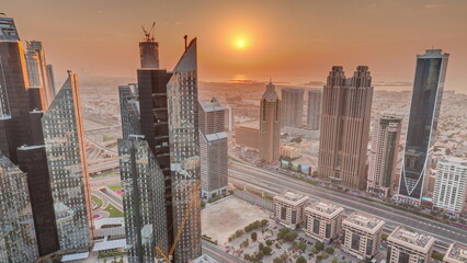 High-rise buildings on Sheikh Zayed Road in Dubai aerial timelapse during sunset, UAE.