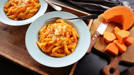 Healthy whole grain Penne, tube shaped pasta with pumpkin, goat cheese