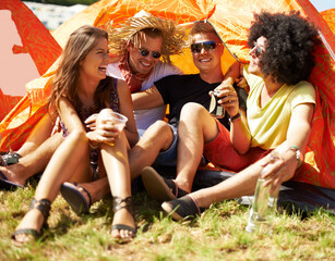 Friends, music festival and tent at camp drinking for fun celebration, party event for holiday...