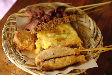 assorted of satay. fish, chicken, intestine chicken. angkringan. nasi Kucing. Indonesian food. sate usus. Gorengan. 