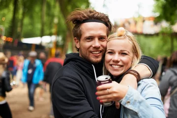 Zelfklevend Fotobehang Happy couple, portrait and outdoor festival for love, care or support at party, DJ event or music. Man and woman hug with smile in embrace, affection or trust for festive or summer celebration © Jeff Bergen/peopleimages.com