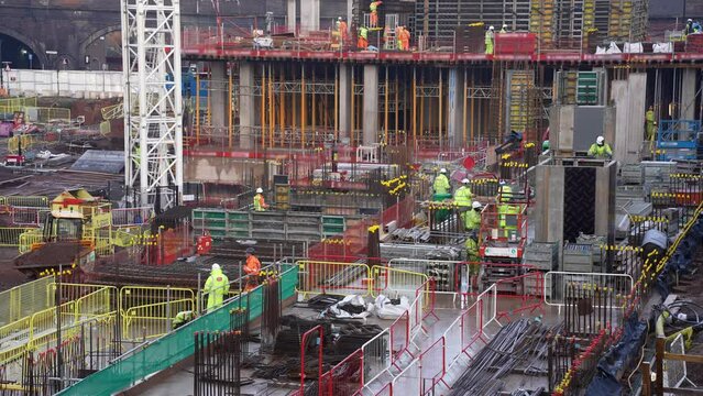 Building site activity.
Construction site full of busy workers. 