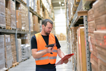 friendly warehouse worker in a warehouse with the barcode scanner