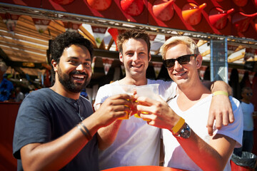 Happy man, friends and cheers at music festival, bar or event for summer party or DJ concert. Portrait of male person or group smile with beer toast for friendship at carnival or outdoor cafe stand - obrazy, fototapety, plakaty