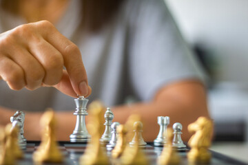 woman playing chess board game for relaxing. Chessboard game for ideas and competition. Close-up photo.