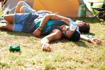 Sleeping, drunk or friends on field in festival hangover in social celebration, party or concert. Fatigue, grass or tired people with alcohol drinks or can on outdoor music event or holiday vacation