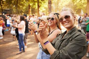Woman, friends and outdoor crowd at music festival for summer holiday, celebration or party concert. Female person, clapping and community dancing in nature excited group, event or social gathering