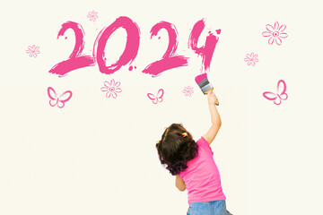 Cute little girl drawing new year 2024 with painting brush on wall background