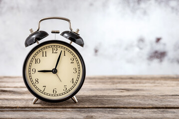 Retro alarm clock on wooden background