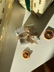 christmas gift box with gold and green ribbon