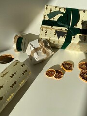 christmas gift box with gold and green ribbon