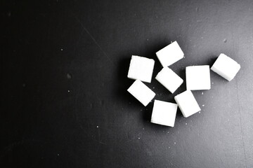 Sugar cubes black Background background iluminated sweet food