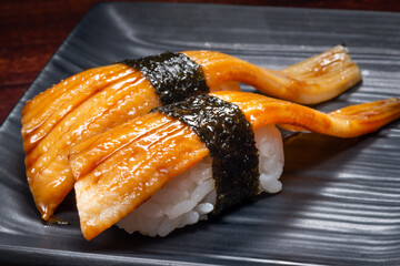 Japanese style of sushi with eel fish on black plate, Asian food, traditional Japanese food