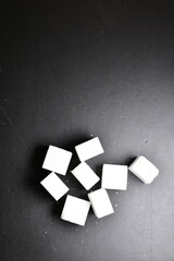 Sugar cubes black Background background iluminated sweet food