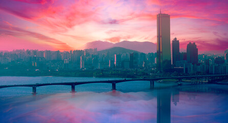 Seoul City Skyline over the Han River at Sunrise with skyscrapers, Mapo Bridge, water reflections, and dramatic surreal cloudscape on Yeouido Island in South Korea