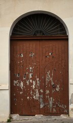 evocative image of old closed wooden door of a country house