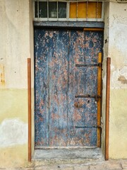 evocative image of old closed wooden door of a country house