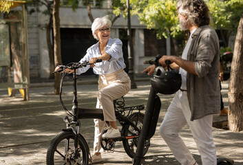 Senior adult couple celebrating Valentine's Day touring the city on bicycles