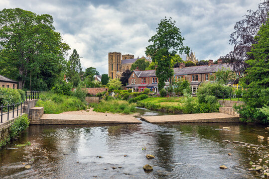 The River Skell in Ripon, with the cathedral standing majestically beyond, in the borough of Harrogate, North Yorkshire.