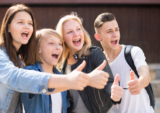 Teenagers show their thumbs up