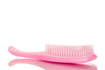 One pink plastic hair brush, macro, isolated on white background.