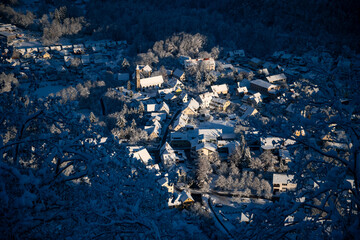 Honau village near Reutlingen in Baden-Wuerttemberg, Germany seen from Lichtenstein castle. Echaz valley and hills of “Schwäbische Alb“ on a cold winter morning with snow. Panoramic view with blue sky - obrazy, fototapety, plakaty