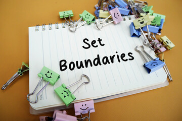 Set boundaries, typography of the word Set Boundaries written on a notebook on a wooden background