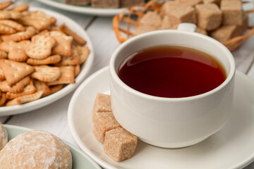 A cup of tea with sweets on the table. Sweet breakfast