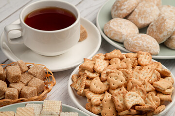 A cup of tea with sweets on the table. Sweet breakfast