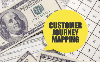 CUSTOMER JOURNEY MAPPING on yellow sticker with pen and calculator
